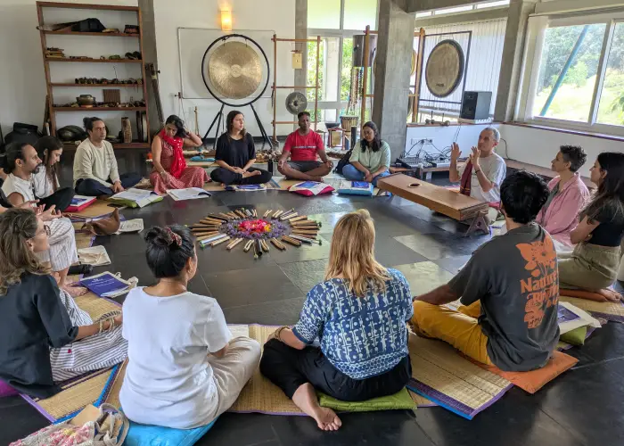 Bild eines Heilklang und Nada Yoga Seminars mit Menschen im Kreis sitzend, in der Mitte vielfältige Instrumente